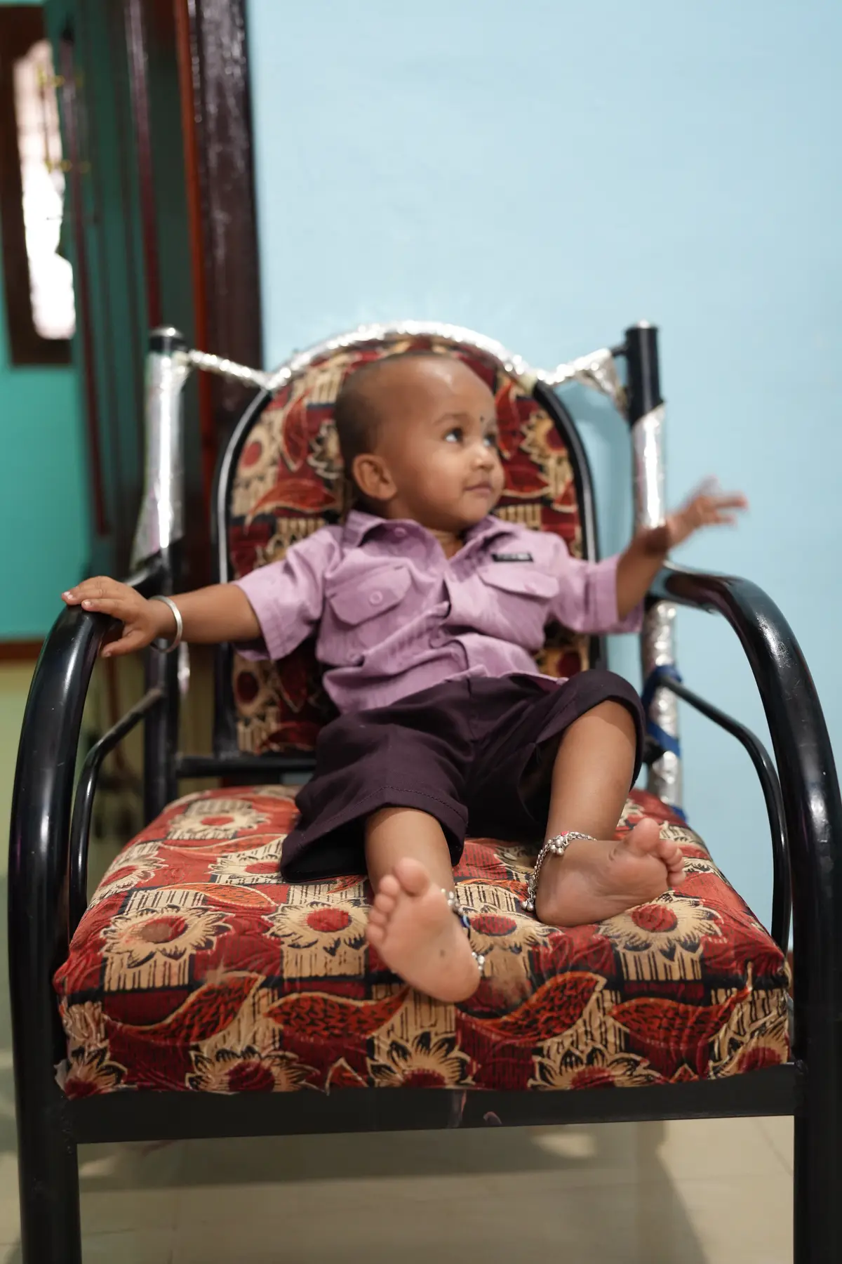 Baby portrait seated on a decorated chair
